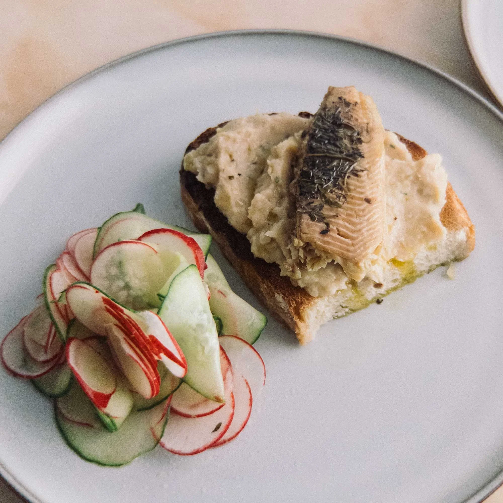 Fangst - Smoked Freshwater Trout plated with white bean puree and thinly sliced pickled salad vegetables .jpg
