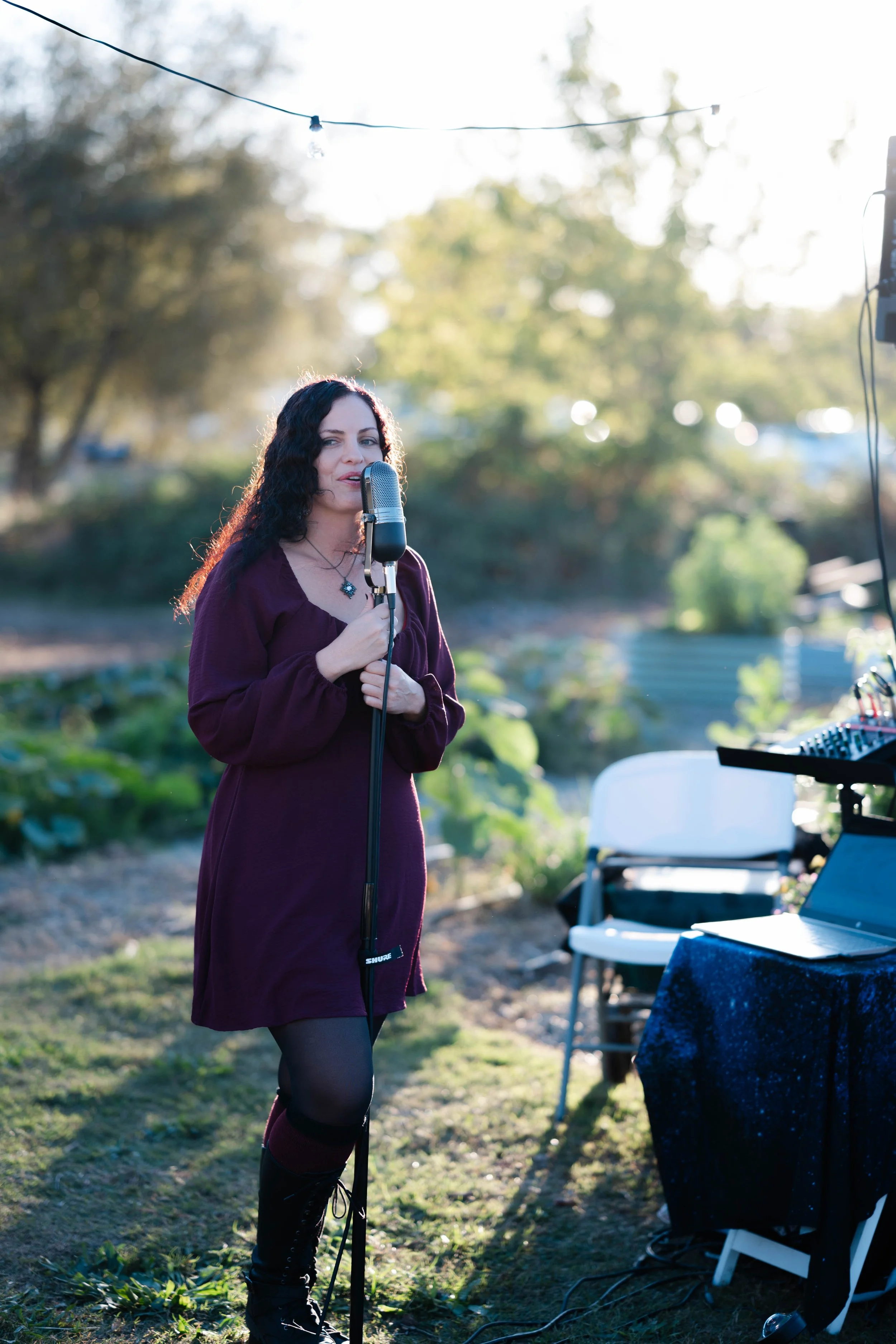 Woman singing in a luxury garden dinner