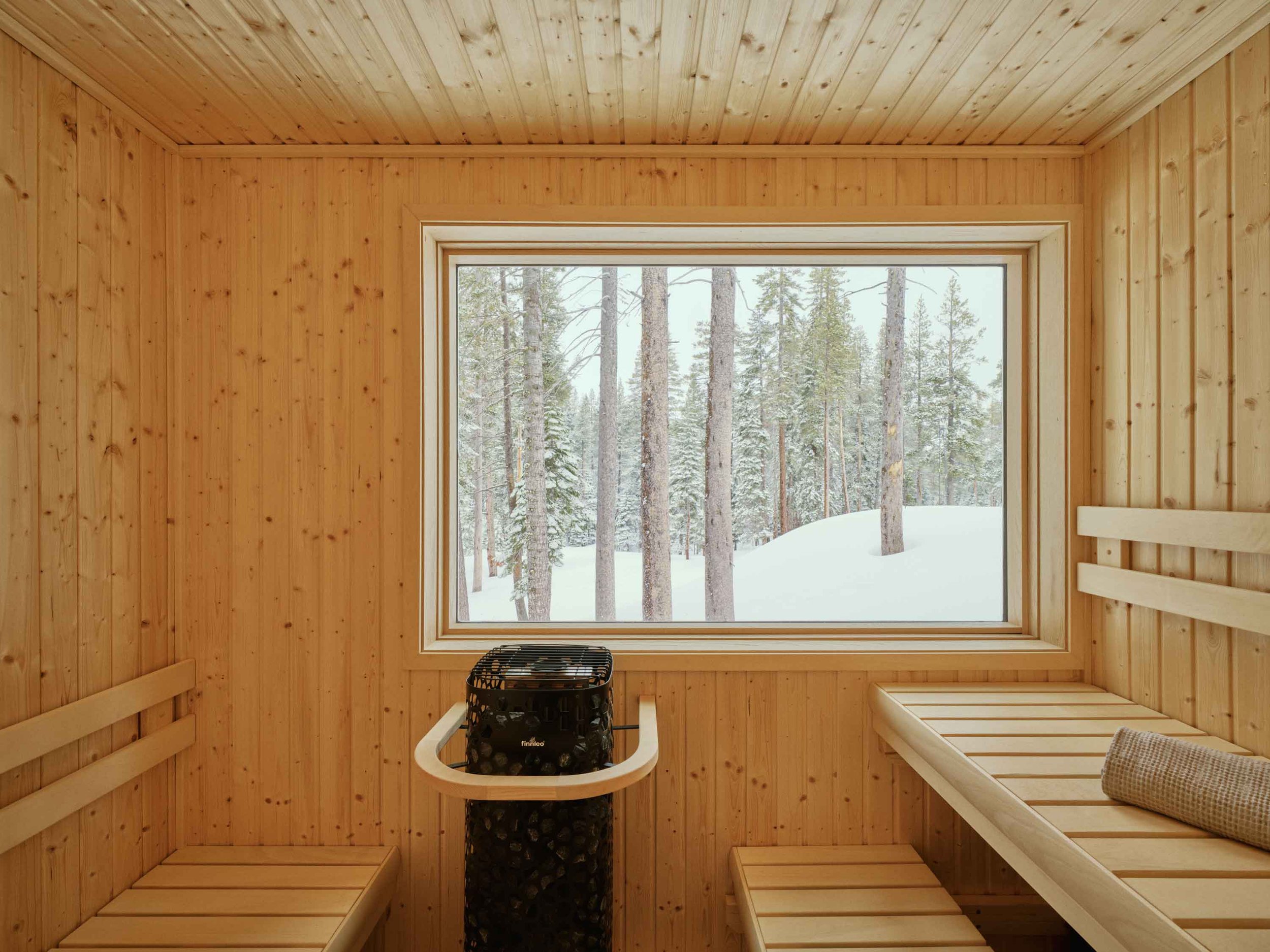 Custom wood sauna with warm cedar interiors, clean lines, and a relaxing spa-like alpine atmosphere