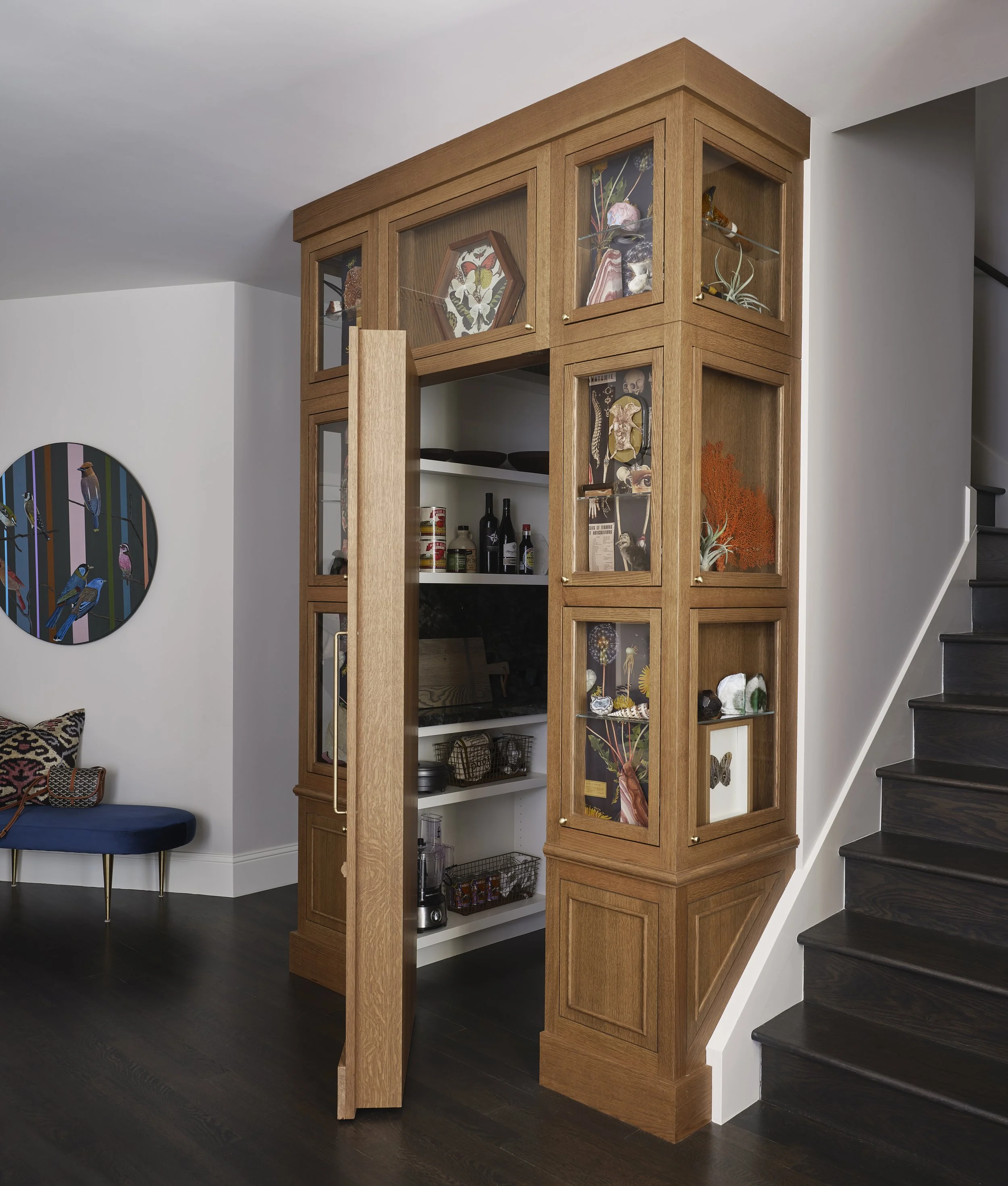 Hidden pantry integrated into colorful San Francisco living room and kitchen design by Eva Bradley Studio with seamless cabinetry and natural textures