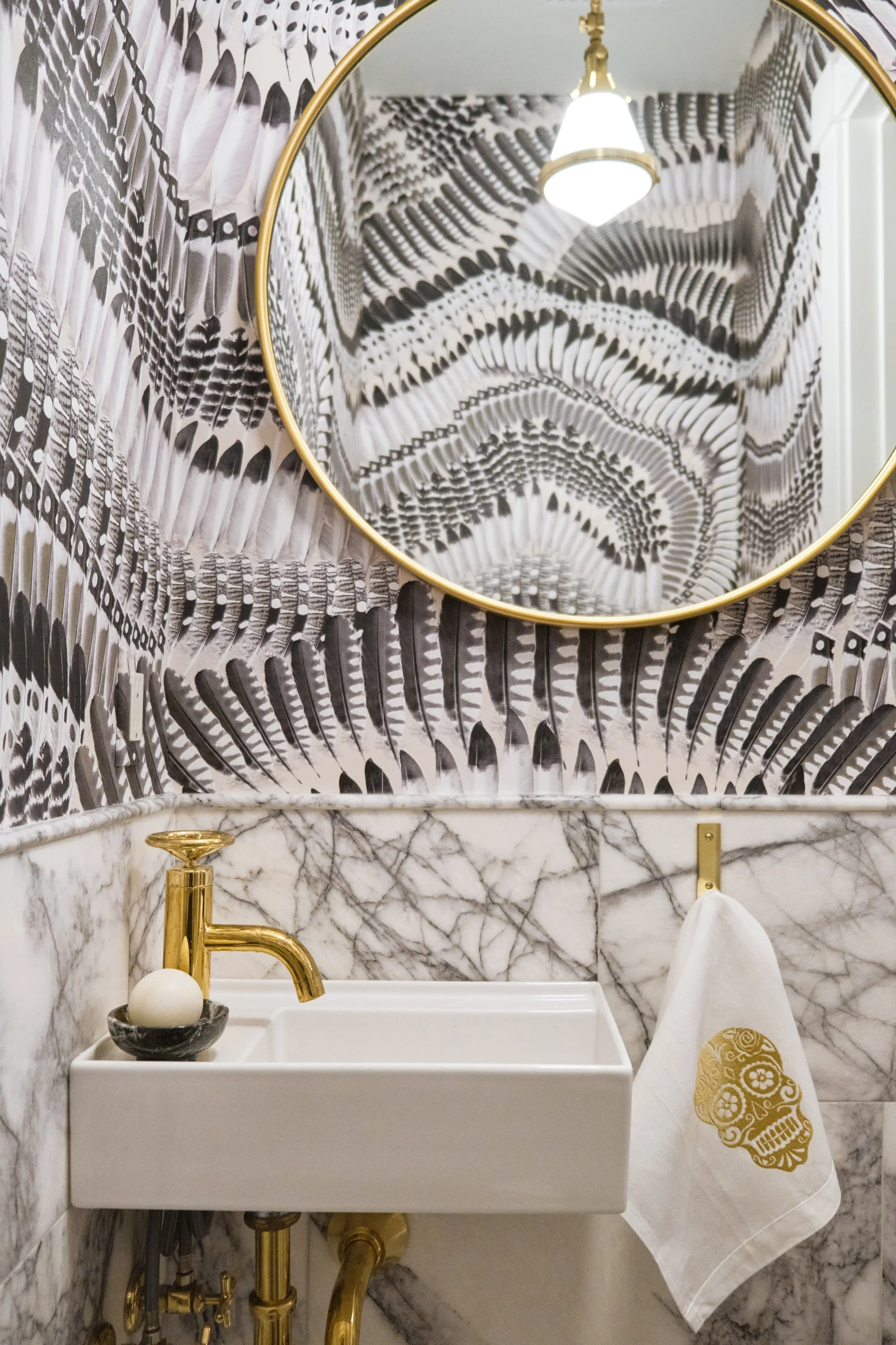 Bold powder room in San Francisco home by Eva Bradley Studio featuring artistic wallpaper and gold toned finishes