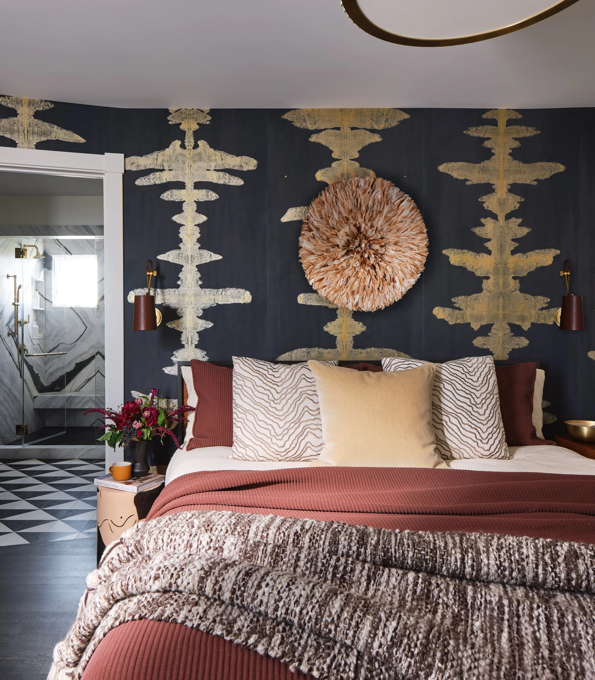 The primary bedroom in this San Francisco home by Eva Bradley Studio featuring bold, nature inspired wallpaper.