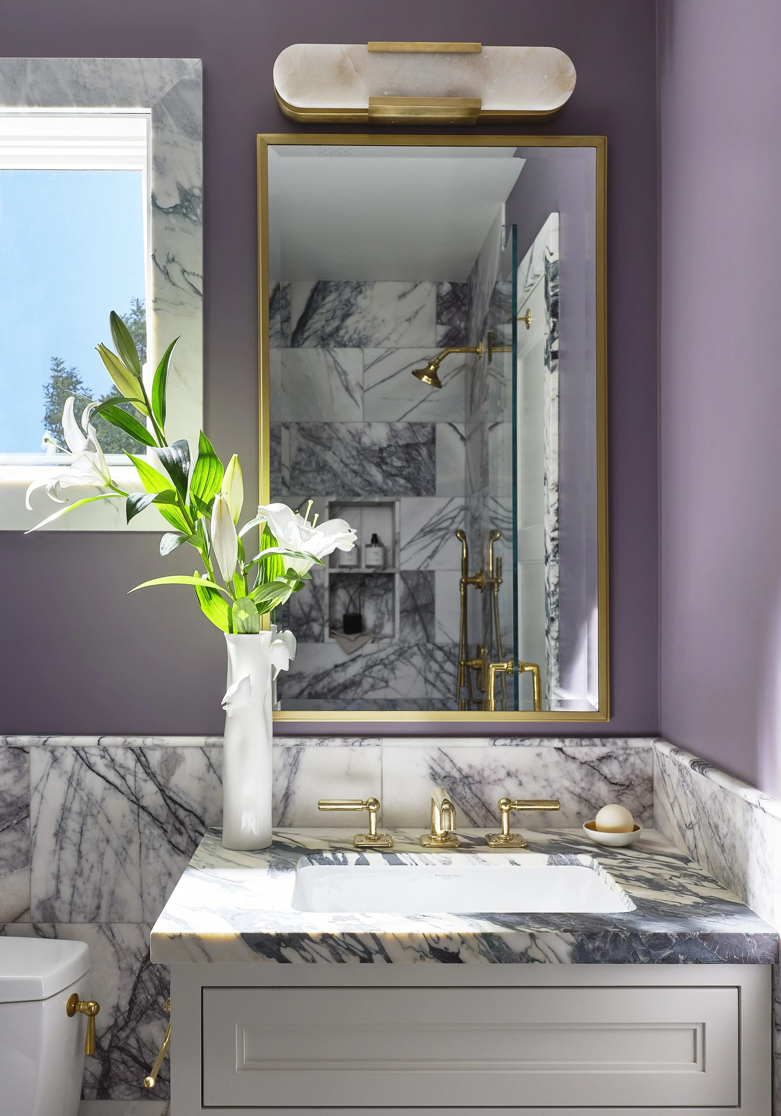 Guest bathroom in San Francisco residence by Eva Bradley Studio with marble finishes and elegant contemporary fixtures