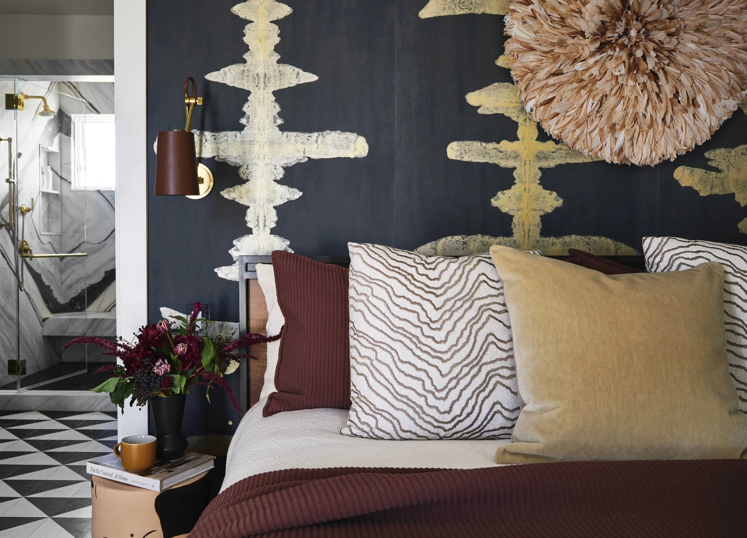 The primary bedroom in this San Francisco home by Eva Bradley Studio featuring bold, nature inspired wallpaper.