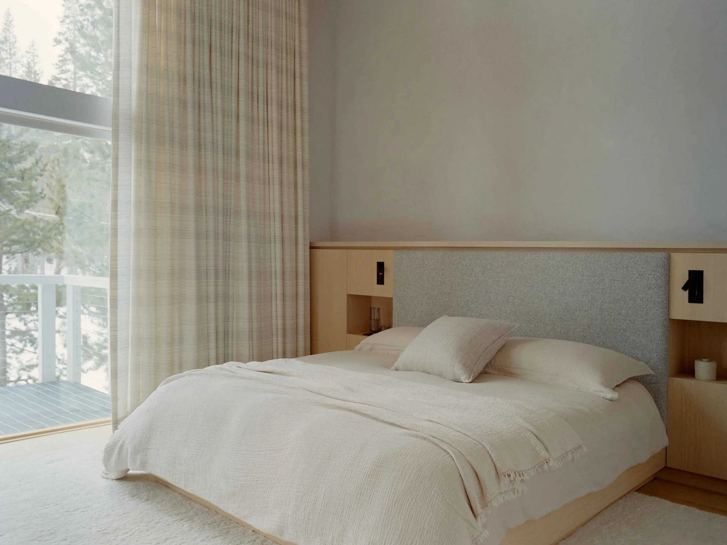 Serene mountain bedroom with soft neutral palette, cozy textiles, and warm wood accents inspired by Swiss chalet design