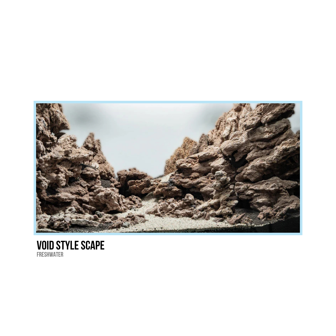 A miniature model representing a rocky canyon or landscape with jagged brown rocks and sandy ground.
