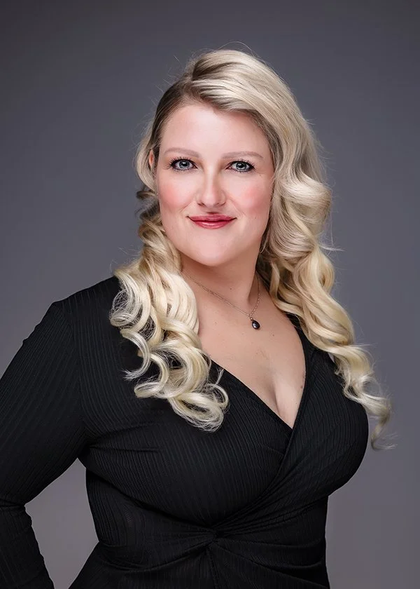 Female headshot long blonde hair black shirt.jpg
