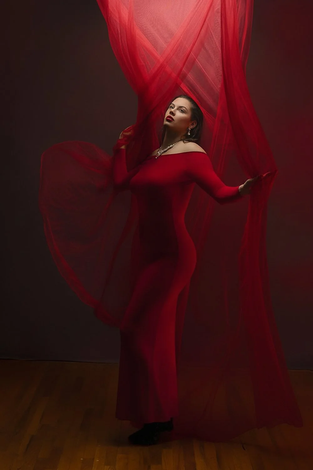 oman in flowing red dress posing dramatically in the Lehigh Valley