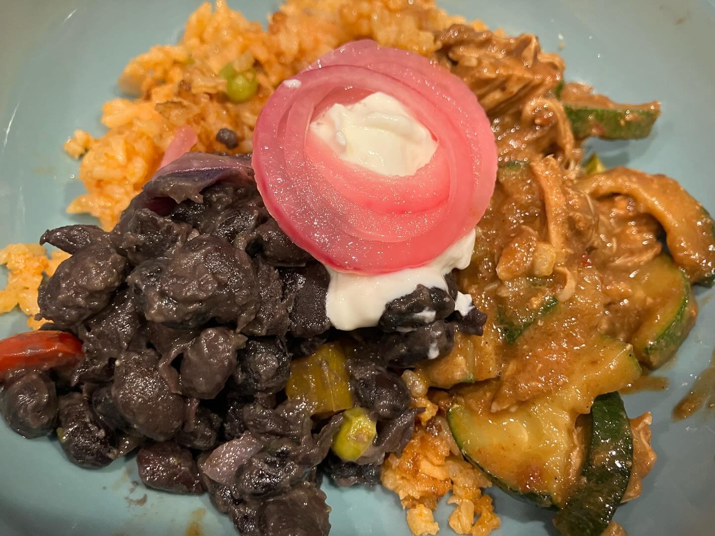Mexican feast:  mole with chicken and zucchini, vegan version with homemade seitan and roast sweet potatoes, black beans, yellow rice, served with pickled onions and &rdquo;cowboy candy&rdquo; (i.e. sweet jalape&ntilde;os). Que rico!