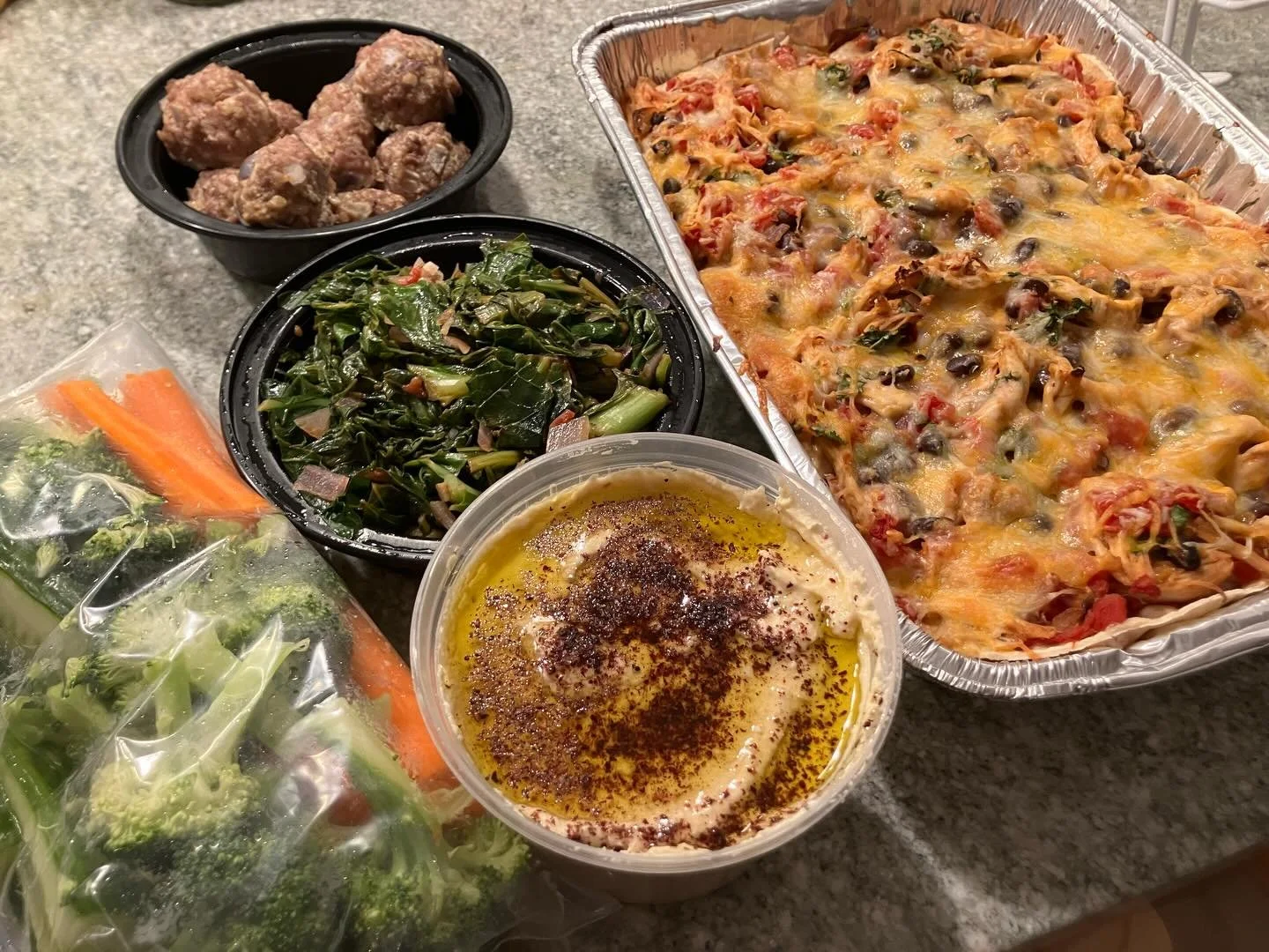 Meal prep!! Chicken enchilada bake, hummus with fresh cut veggies, saut&eacute;ed greens, and turkey meatballs. Lean protein and plenty of nutritious veggies.