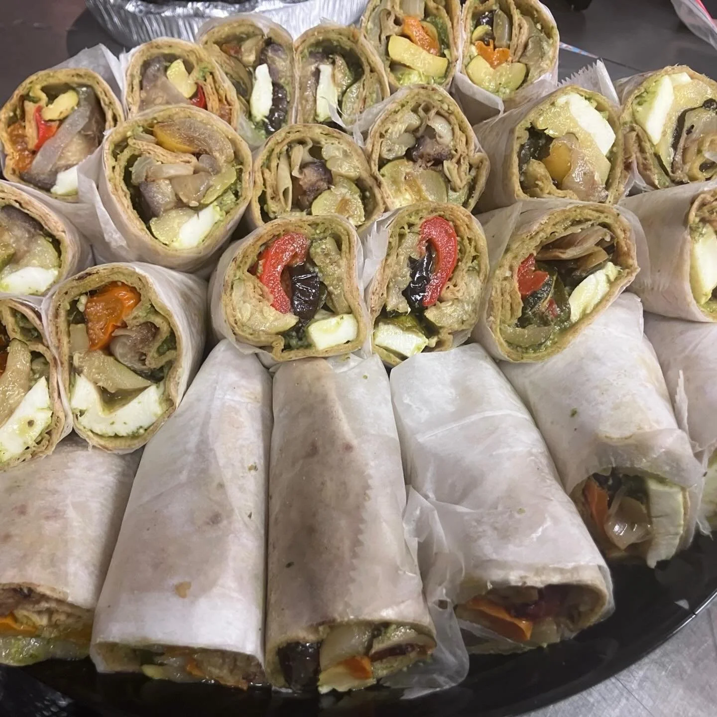 Deluxe catering for Queer Prom!! Roasted veggie on lavash with pesto and fresh mozzarella or hummus, turkey and Swiss wraps with honey mustard sauce, vegan burgers with vegan mayo-ketchup-sriracha, roast beef and cheddar with caramelized onions and c