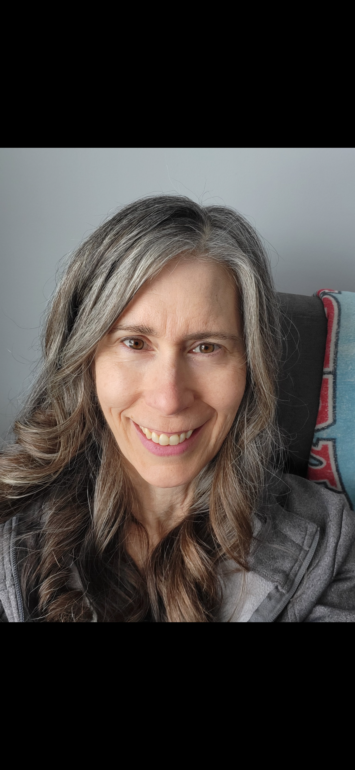 picture of a middle aged lady with long salt and peper hair