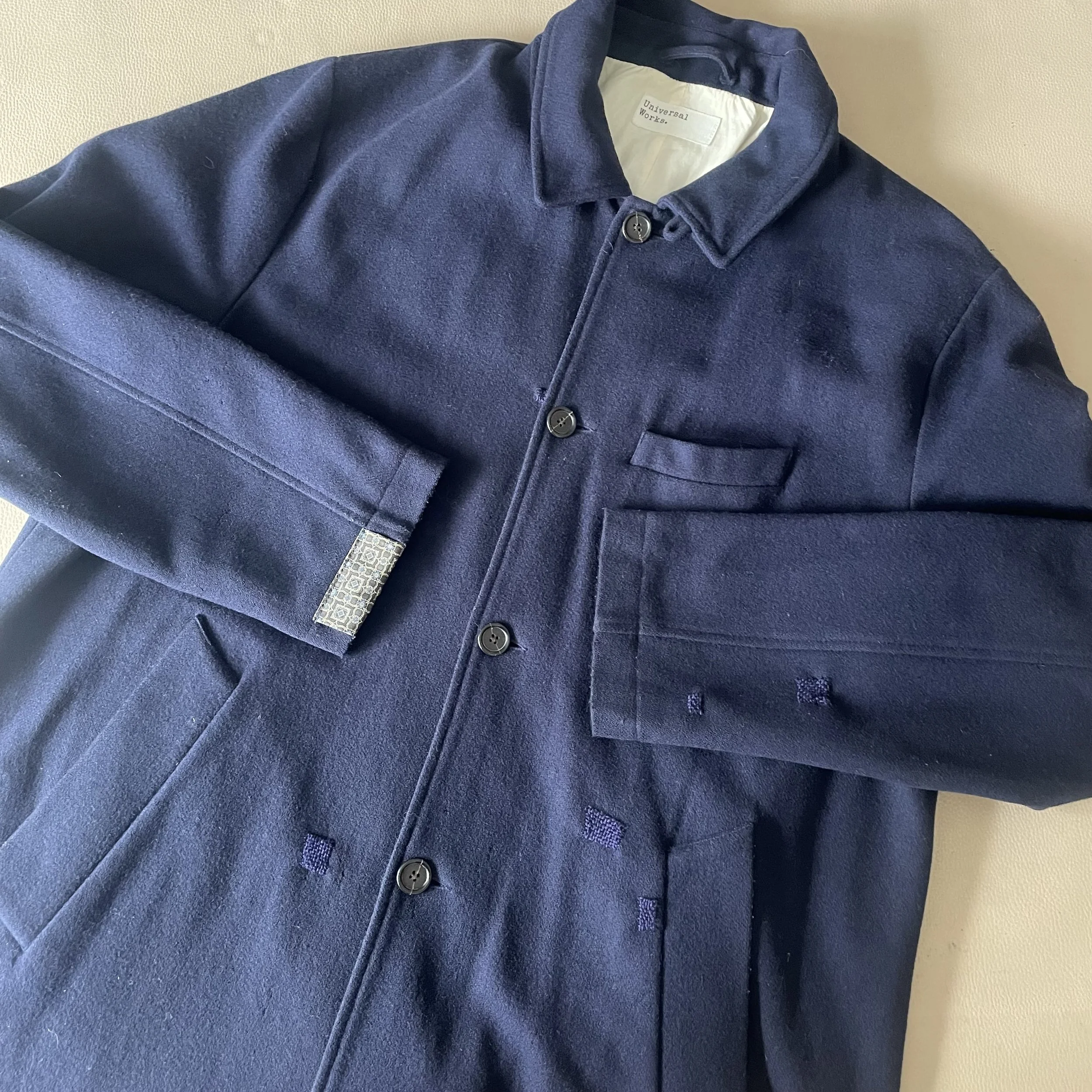 Wool coat visible mending