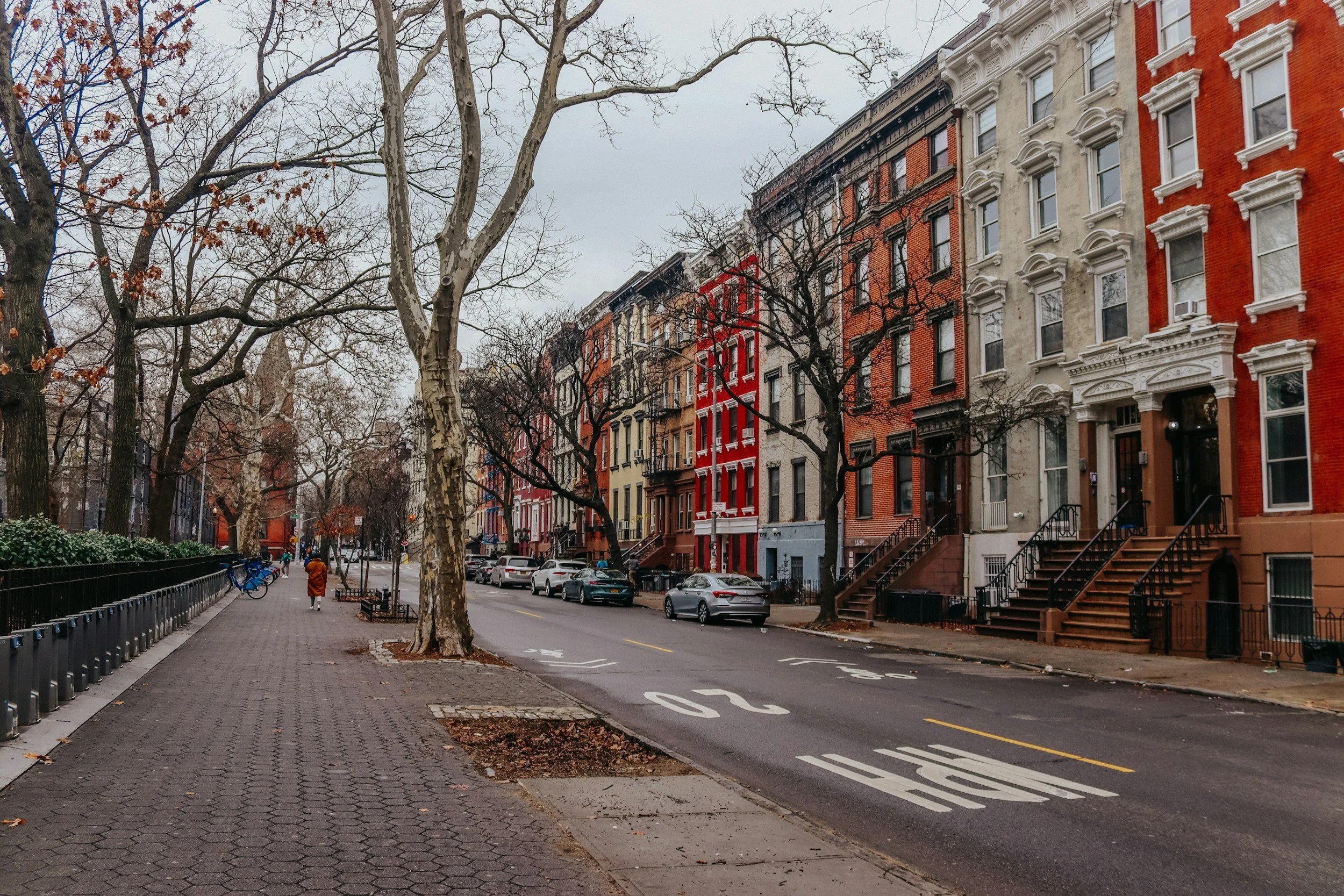Brick buildings on a city street with trees
