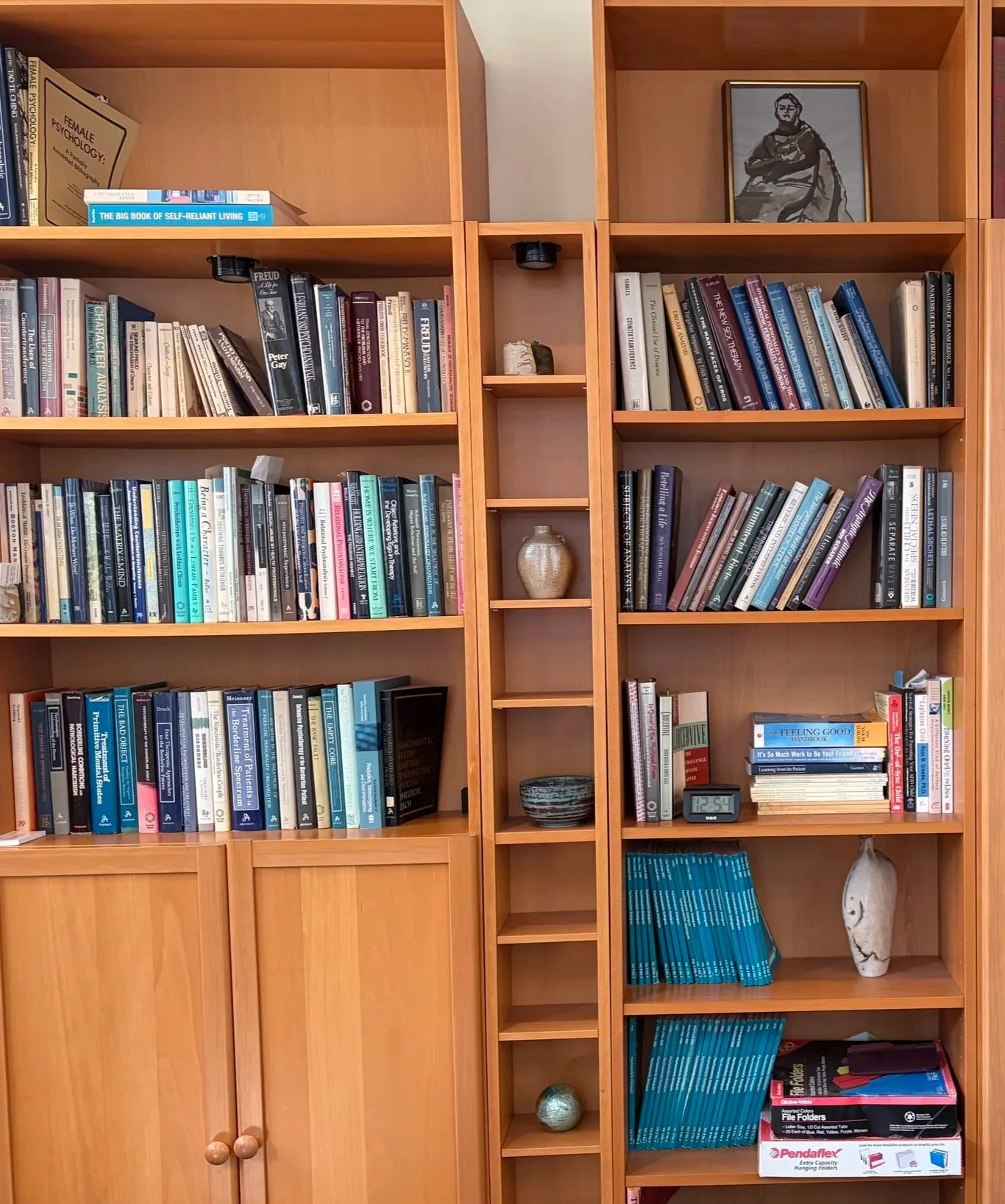 Wooden bookshelf filled with books and decorative items.