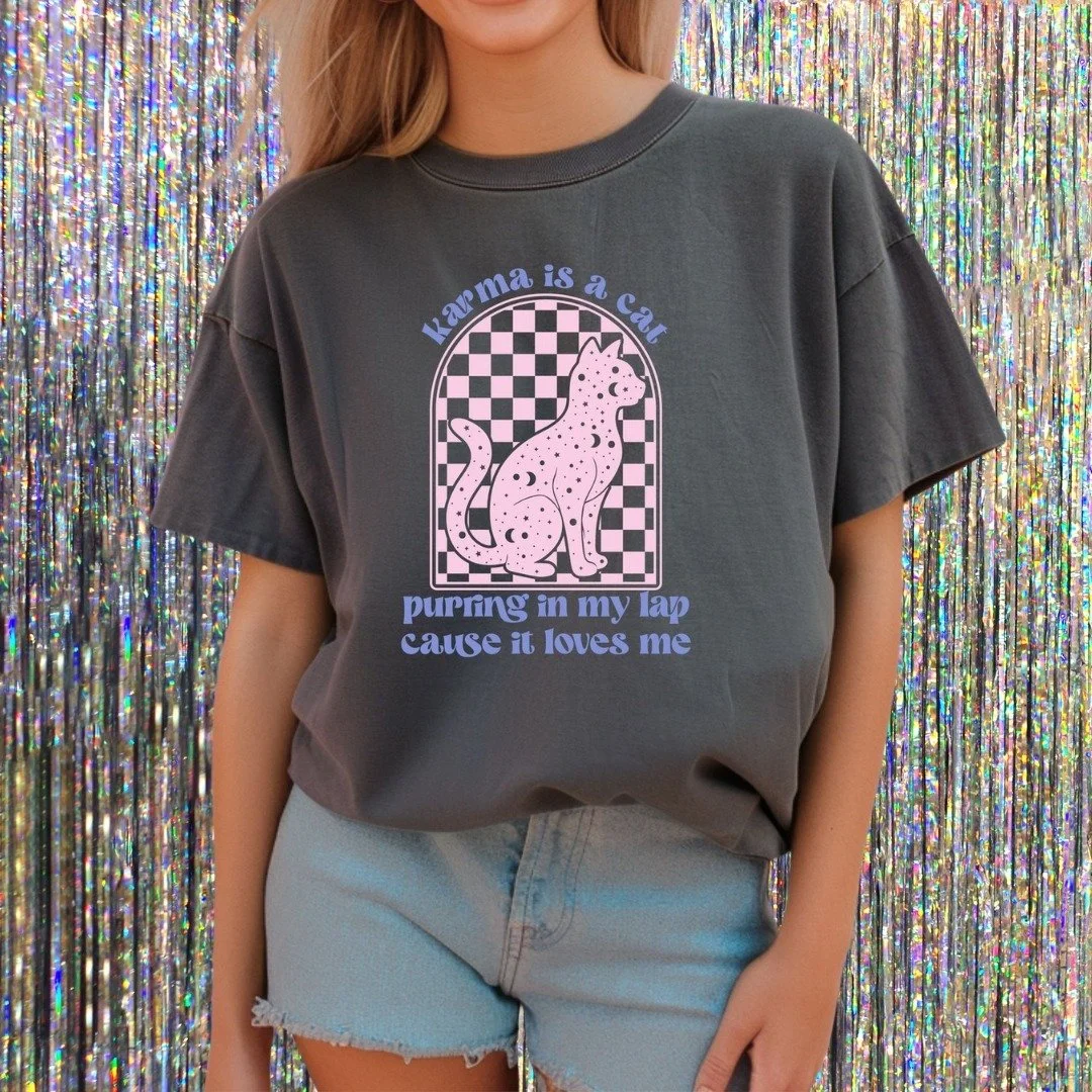 ✨ Here&rsquo;s to a purr-fect 2025! 🐾 

Start the year off right with good vibes, great karma, and cozy style. Grab this tee and use code SWIFTMAS for 15% off! 🎉 

#KarmaIsACat #NewYearNewFeels