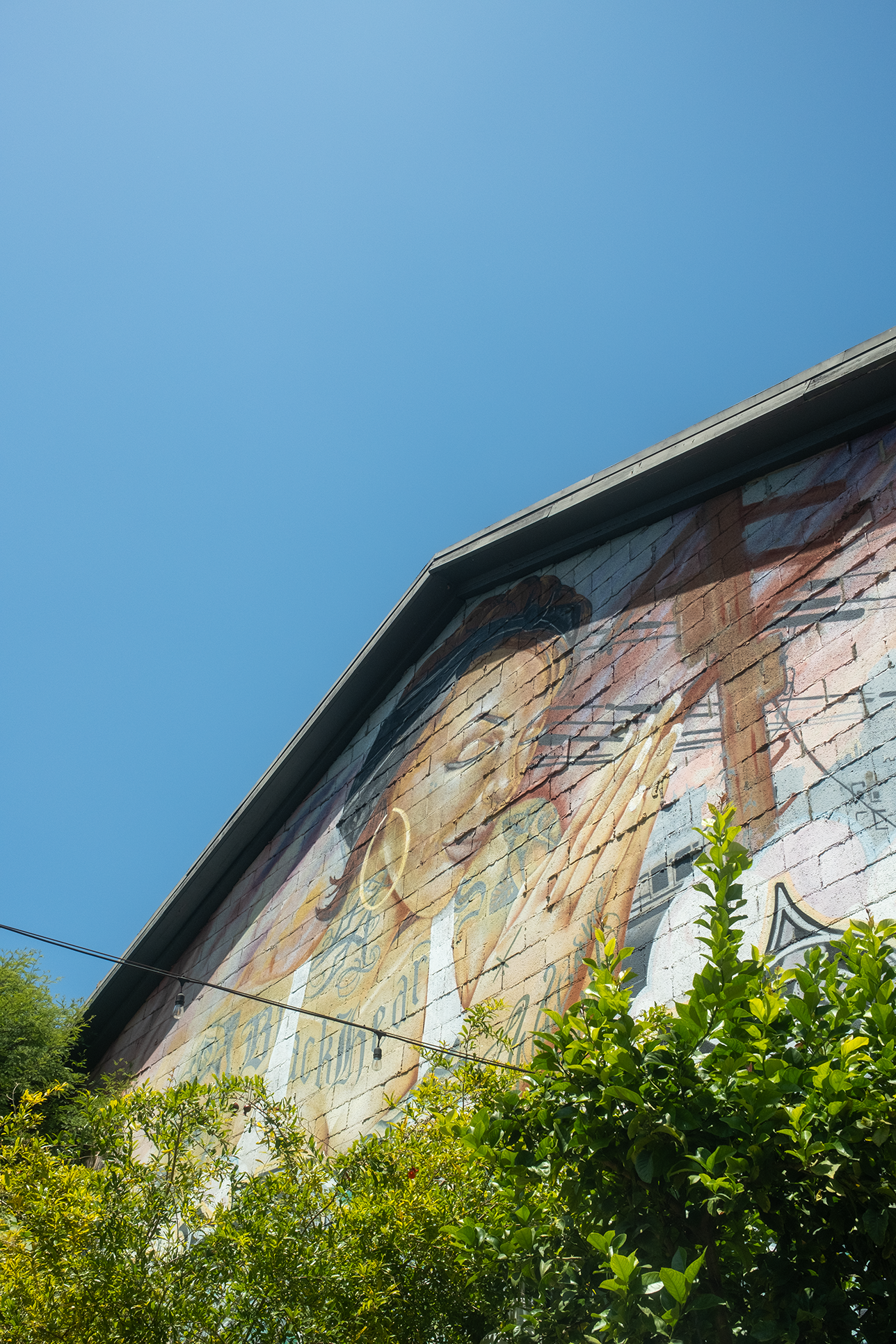 Photo of a mural of a woman with her hands in a praying formation. —  IFS Therapist for Burnout in Downtown Los Angeles