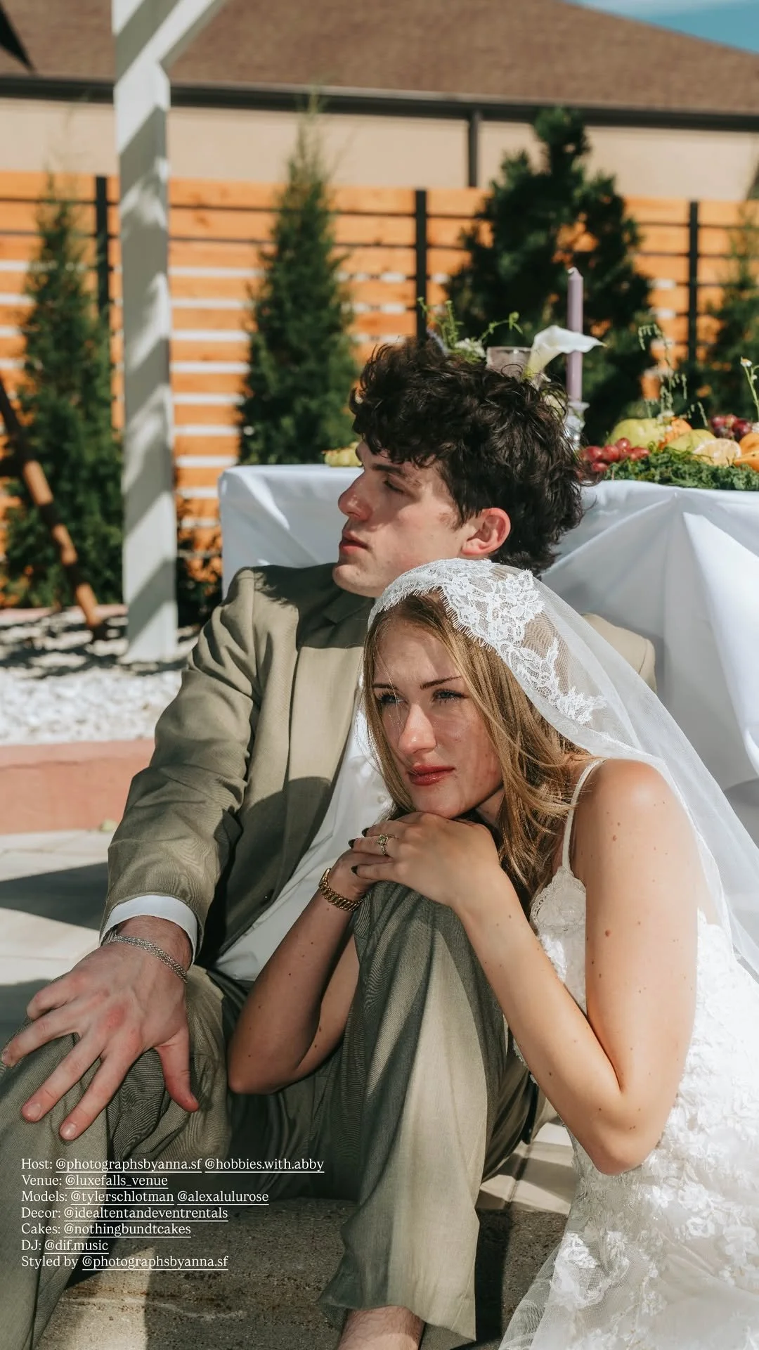 Bride and groom seated together beneath the outdoor pergola at LuxeFalls Venue in Sioux Falls.