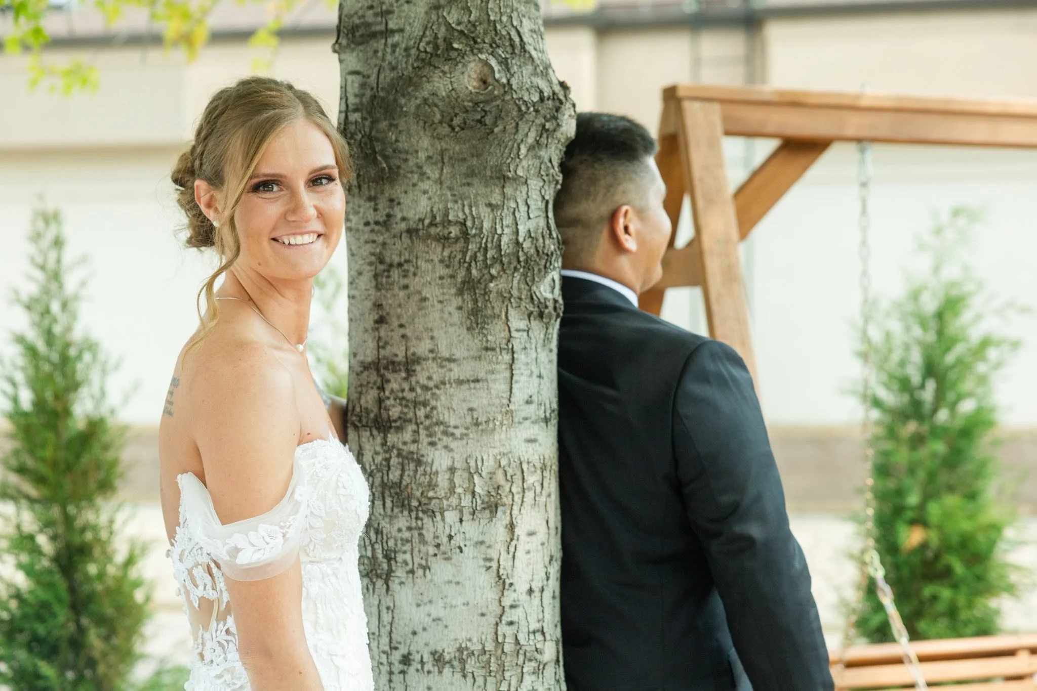 Bride smiling during a first look moment at LuxeFalls Venue in Sioux Falls, SD. A beautiful outdoor wedding photo showing joy and elegance at this modern Sioux Falls wedding venue.