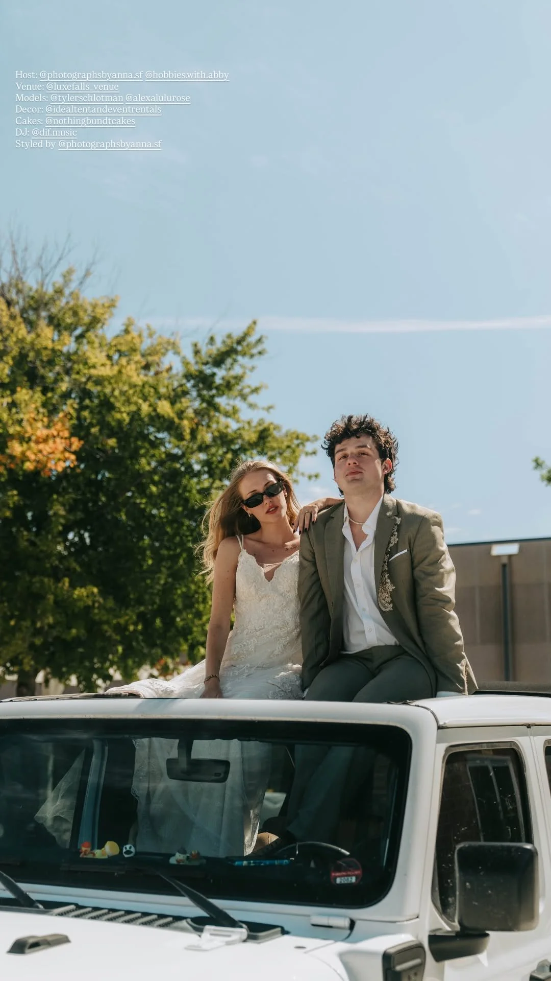 Bride in sunglasses and groom in an olive suit posing outdoors at LuxeFalls Venue in Sioux Falls.
