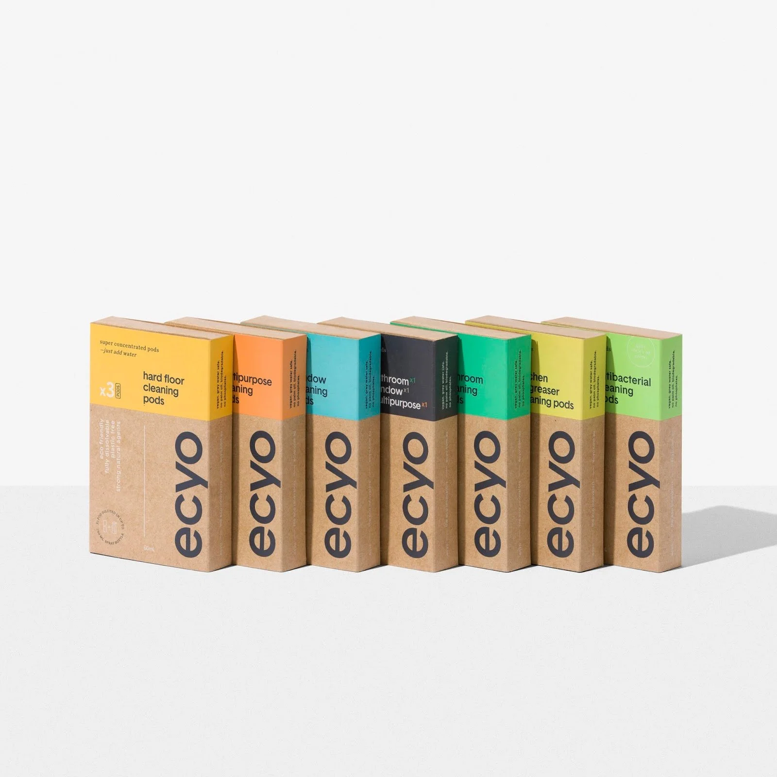 Row of Ecomo cleaning products in colorful boxes, including floor cleaning, bacteria cleaning, and purpose-specific cleaning pods, arranged on a white surface.