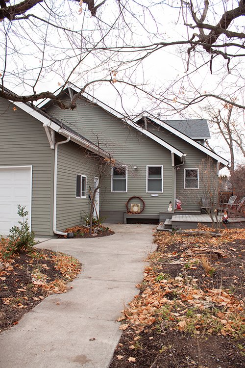 The front of the home features a triple tiered roof design.