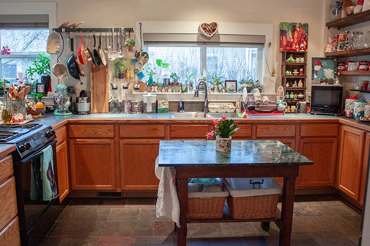 The kitchen was upgraded to include new appliances and flooring as well as added open wood shelving for design.