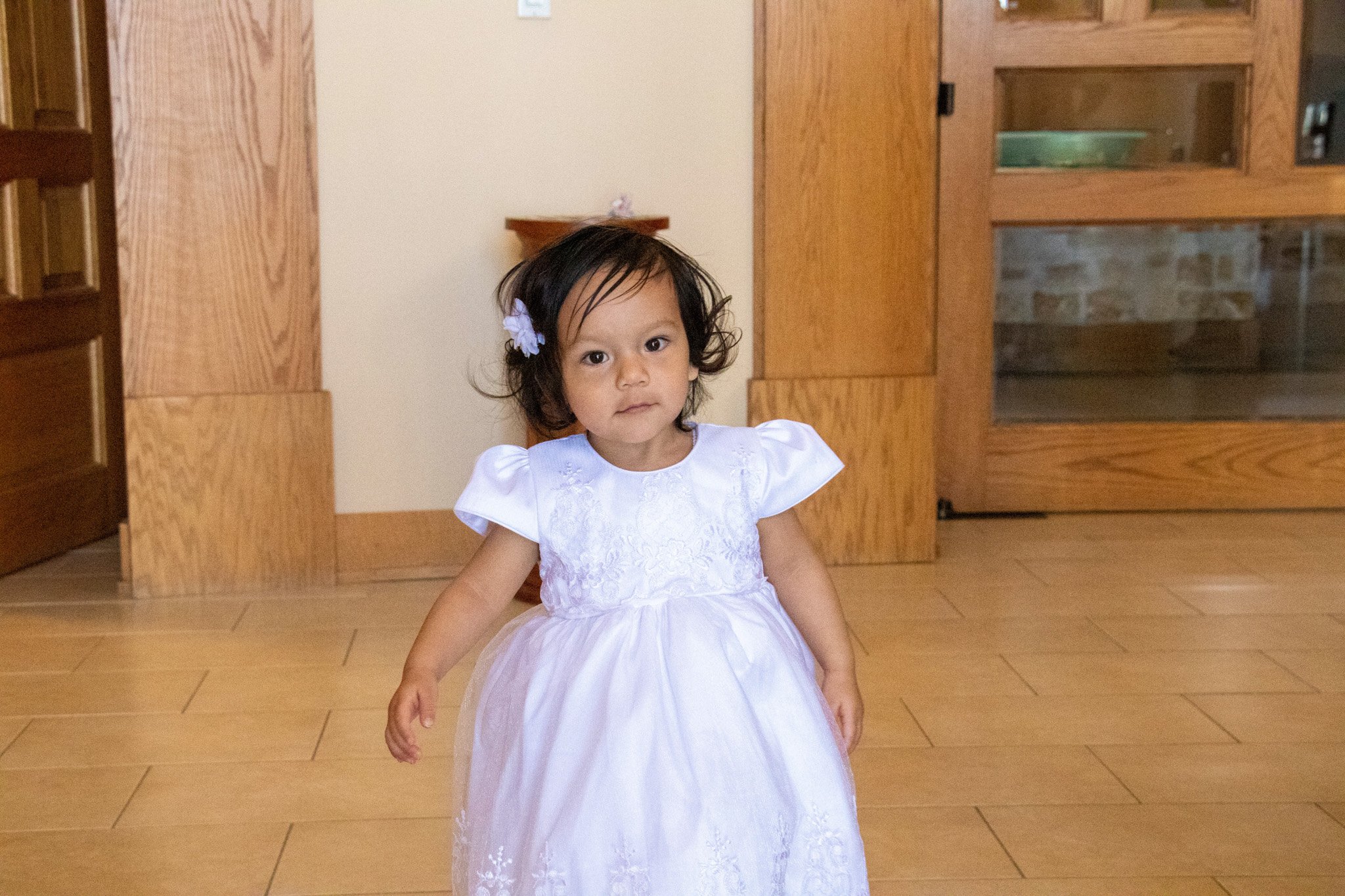 Little girl staring curiously at the camera.