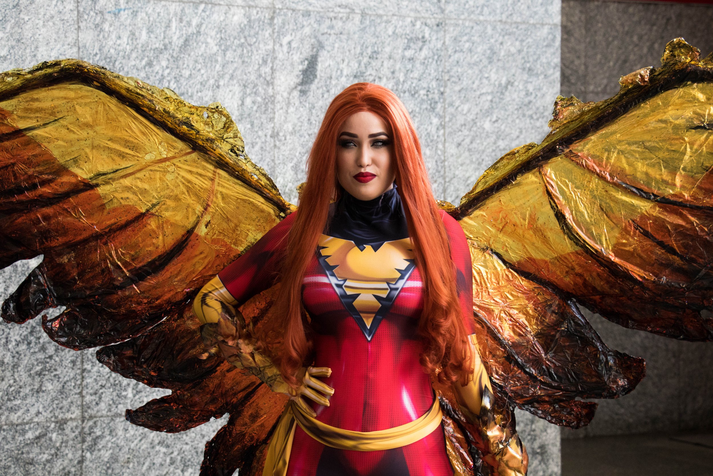 Woman cosplaying as "Dark Phoenix" from the X-Men comics and movies.