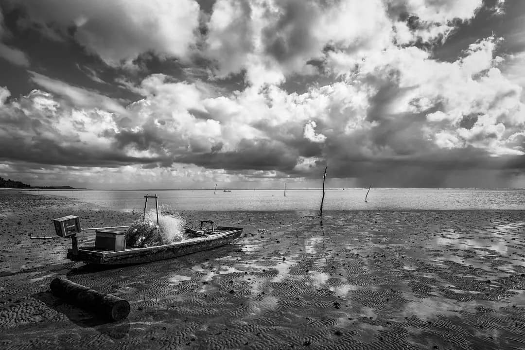 A distant storm rolls out to sea along with the tide, leaving this boat motionless in the sand. The tide would get so low that you could walk all the way out to the reef in no more than knee-high water.
#brazil #fishing #fishingboat #patacho #southa