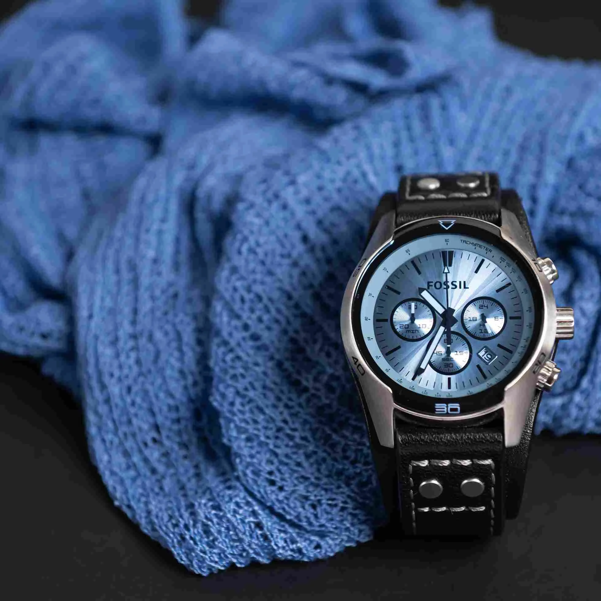 Fossil men’s watch styled with blue knit fabric on black base