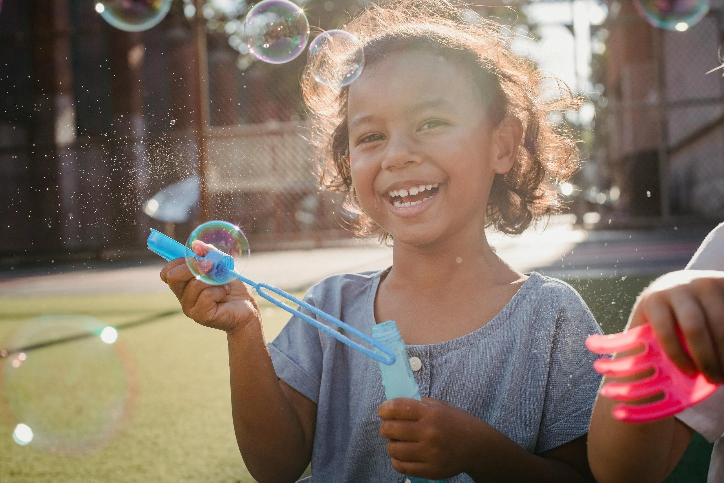 child blowing bubbles