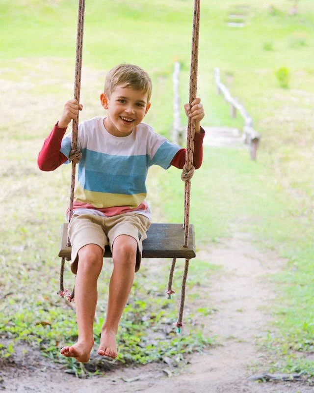 young boy on a swing