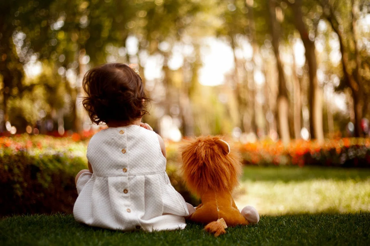 child with stuffed pet dog