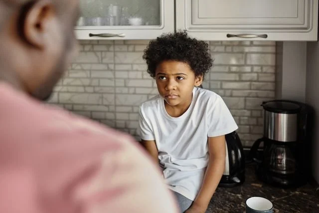 child talking with his father