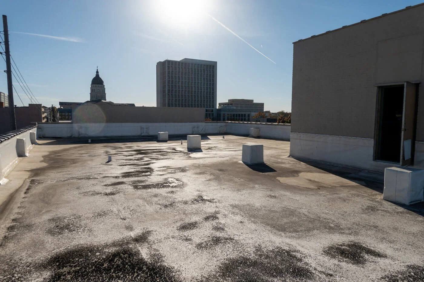 Old and leaking PVC roof in downtown topeka kansas needing to be torn off
