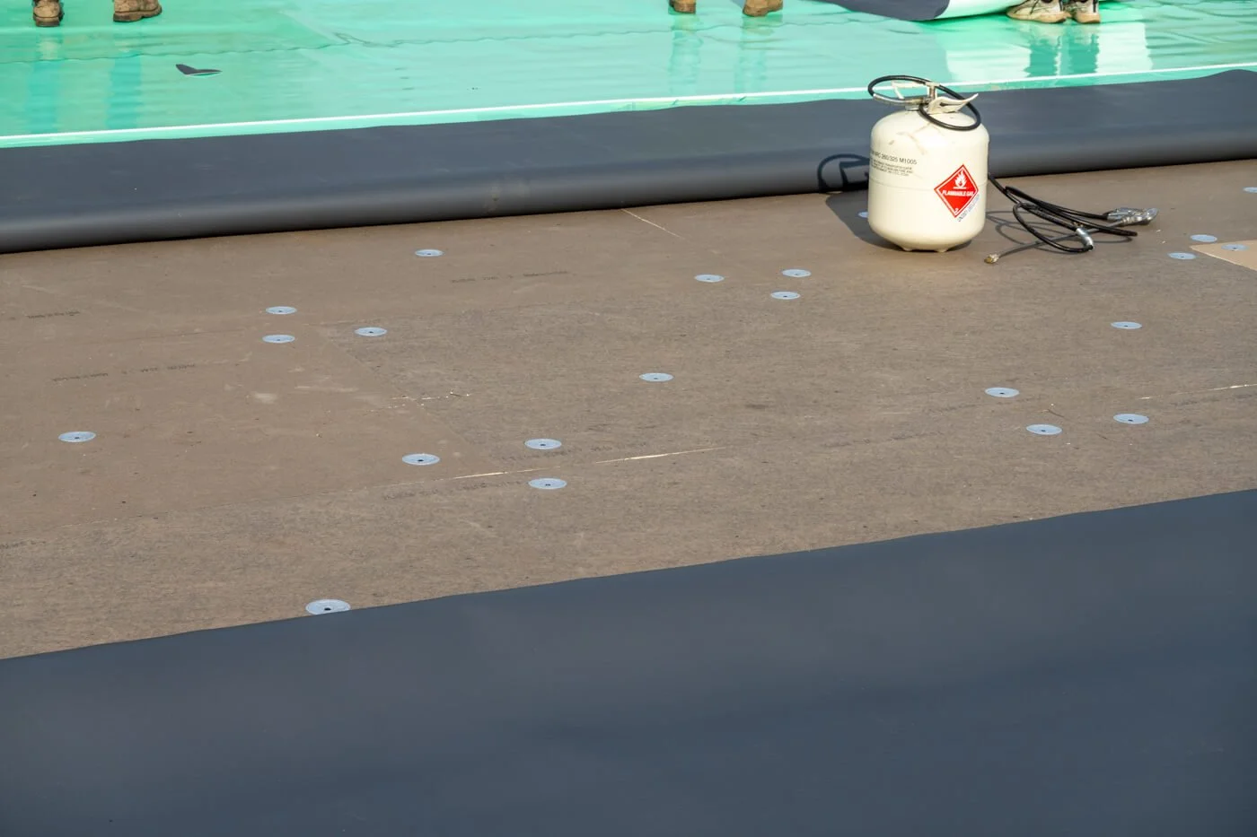 GAF TPO being fully adhered to ISO insulation boards, fully fastened