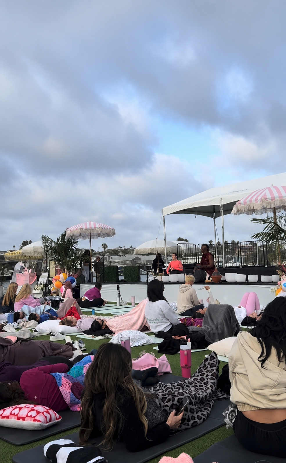 Sandy Duarte leading a healing sound bath at Drenched OC using crystal singing bowls for deep relaxation and wellness.