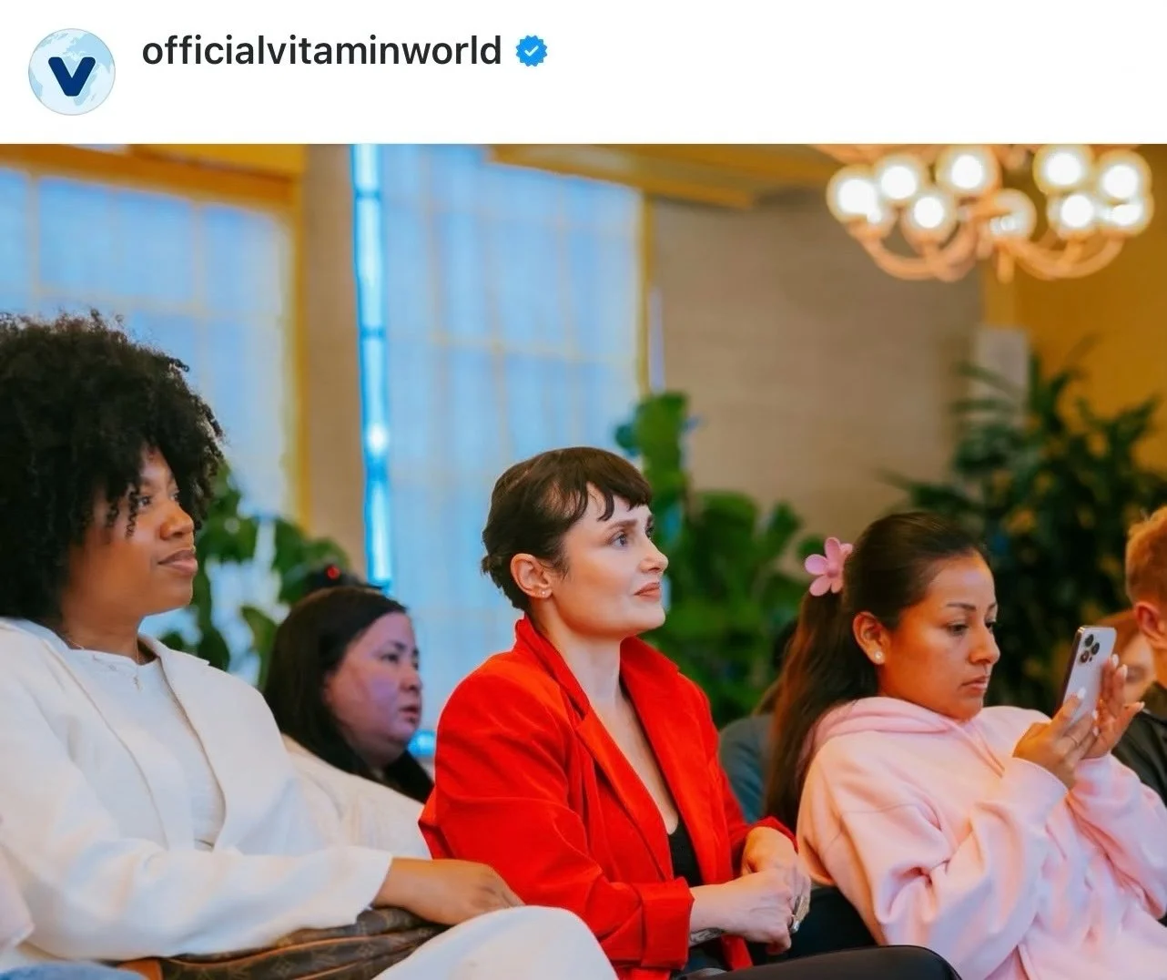 Sandy Duarte leading a wellness experience at a Vitamin World event, guiding participants through mindfulness, sound healing, and relaxation.