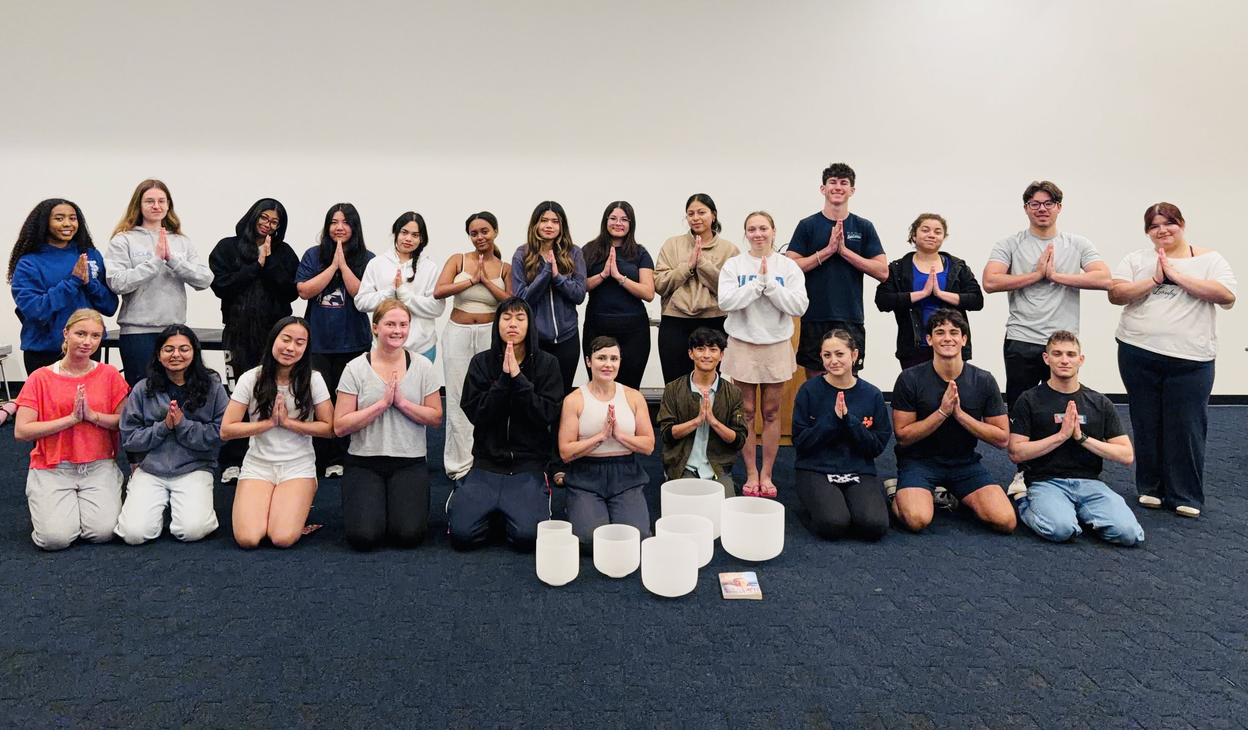 Sandy Duarte leading a restorative sound bath at UCLA with crystal singing bowls to promote relaxation, mindfulness, and well-being.