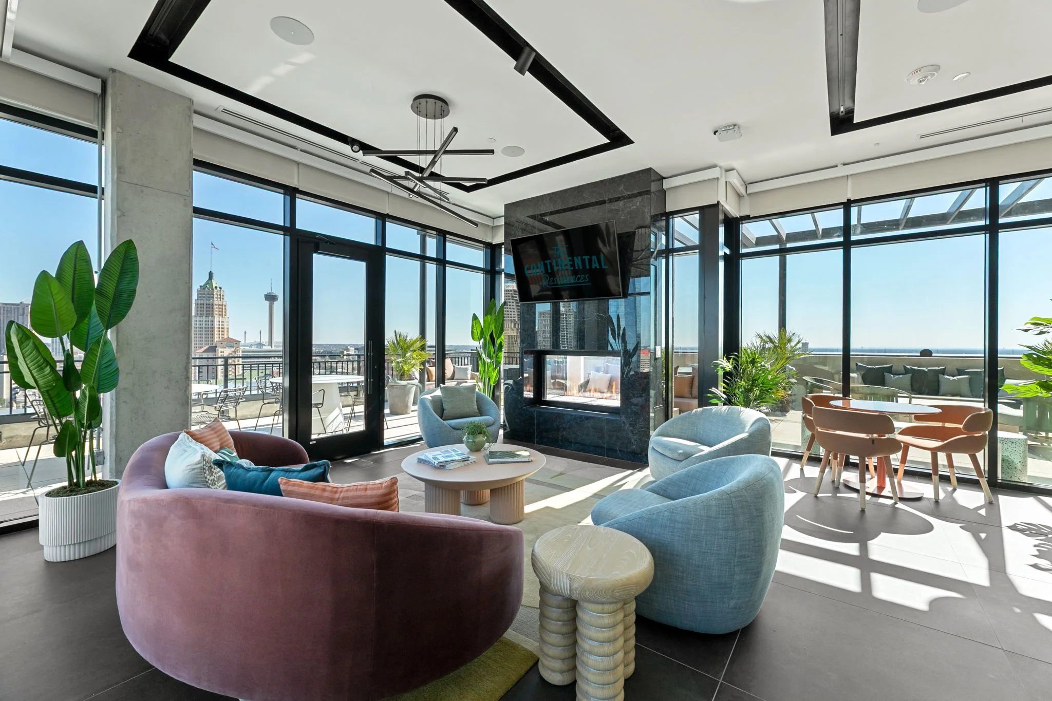 Continental Residences rooftop bar with outdoor seating and city skyline views