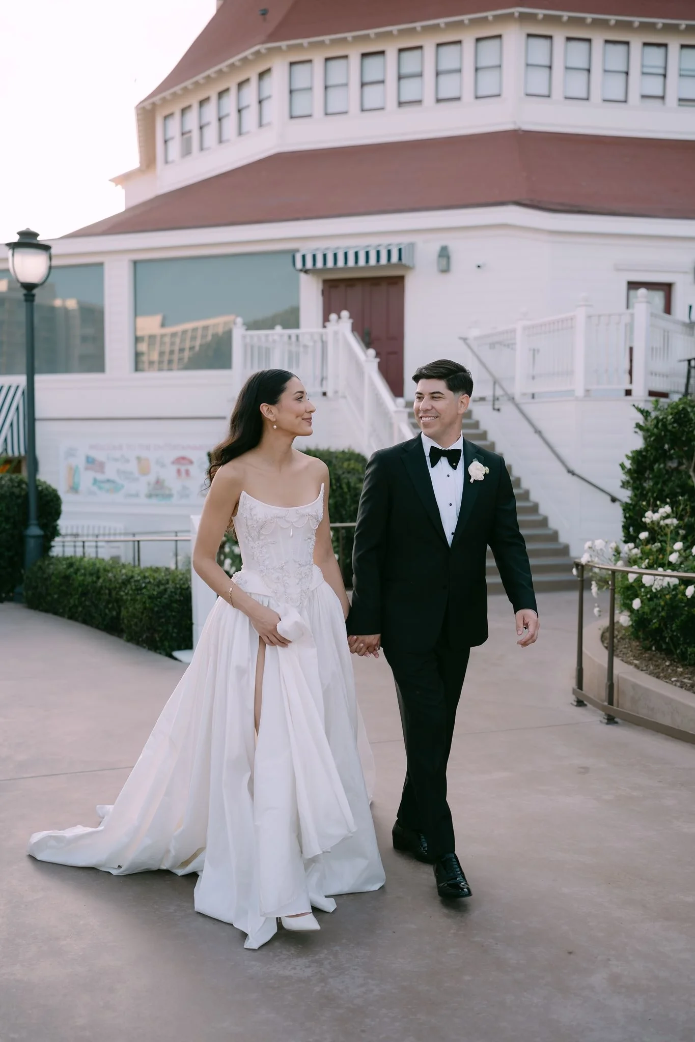 hotel-del-coronado-wedding-couple-walking-near-crown-room.webp