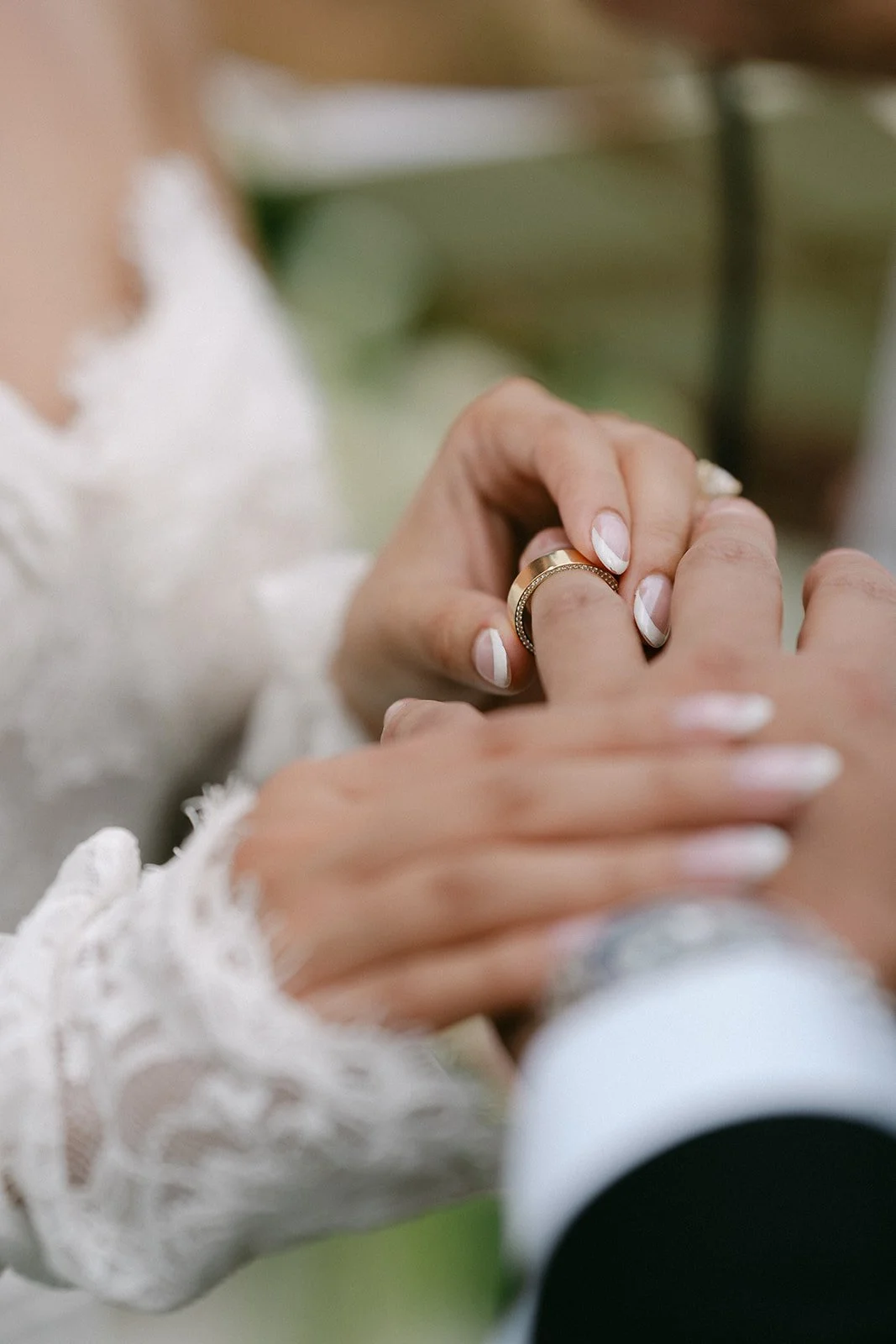 Bride putting on groom's ring