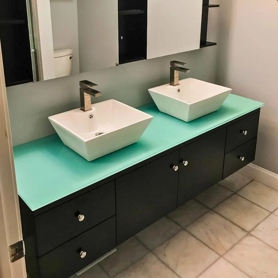 Transforming bathrooms into contemporary sanctuaries. ✨ This recent renovation showcases sleek vessel sinks, a striking teal countertop, and modern floating cabinetry for an upscale, clutter-free aesthetic. 

Ready to bring fresh style to your own sp