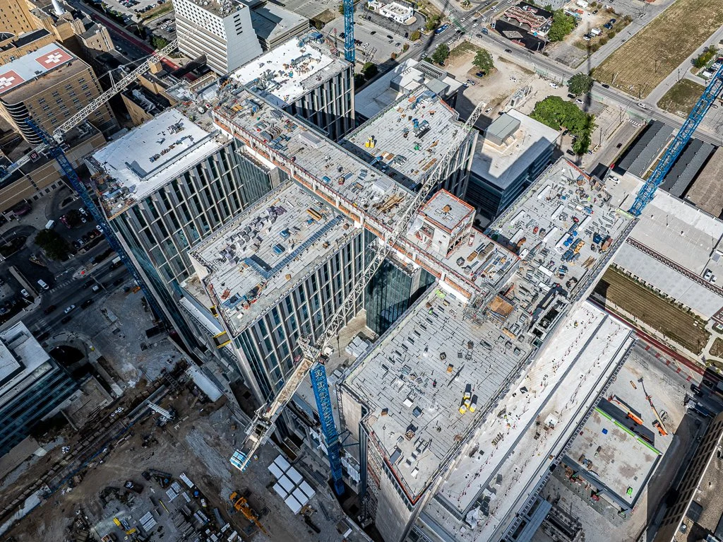 Aerial view of a construction site with various structures and machinery.