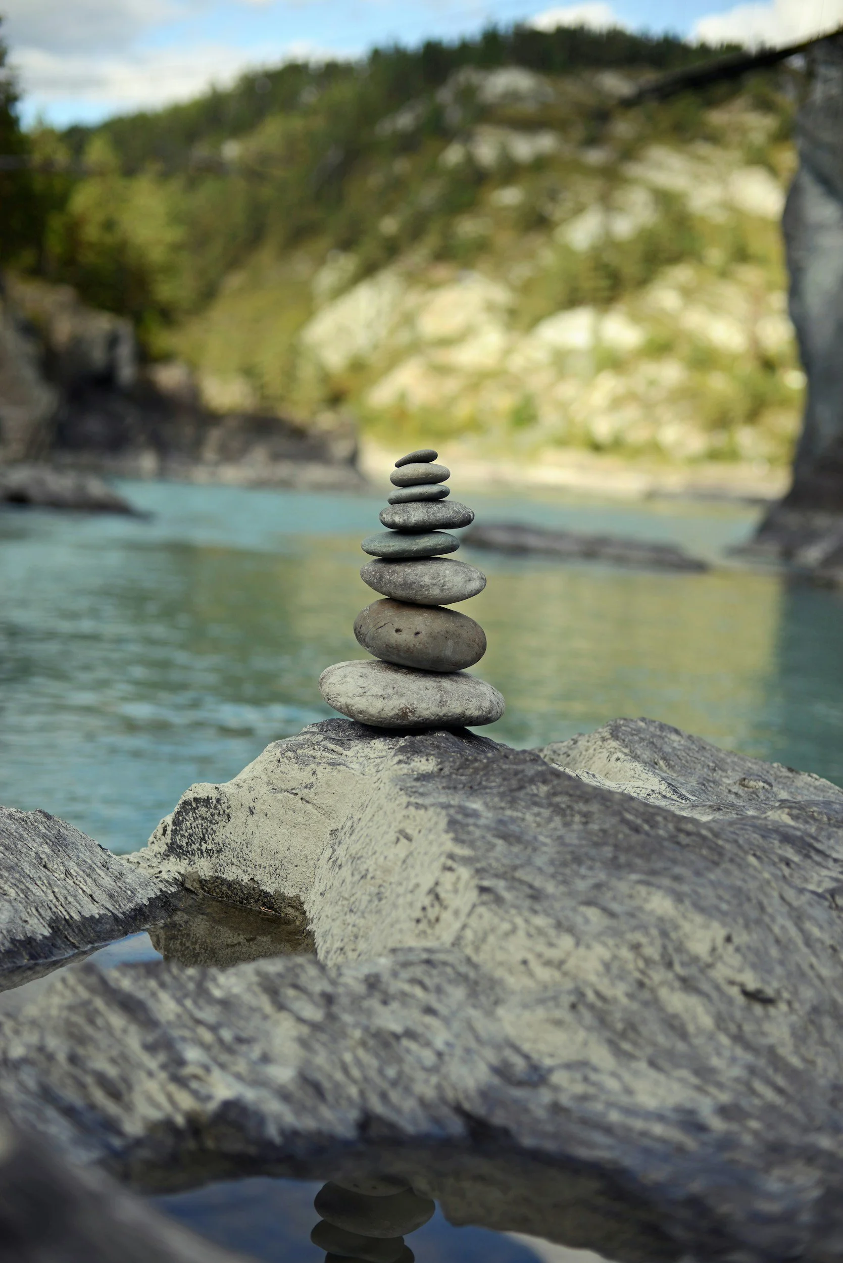Cairn (balanced stones stacked on top of each other) at the river, a symbol of mindfulness, calm, peace