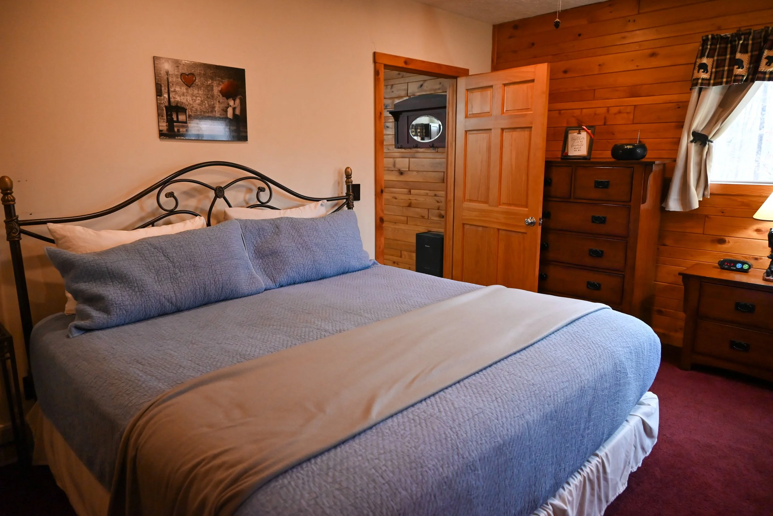 Romantic king‑bedroom at Beary Cozy Cabin featuring warm wood accents and soft bedding, ideal for couples enjoying a peaceful escape.