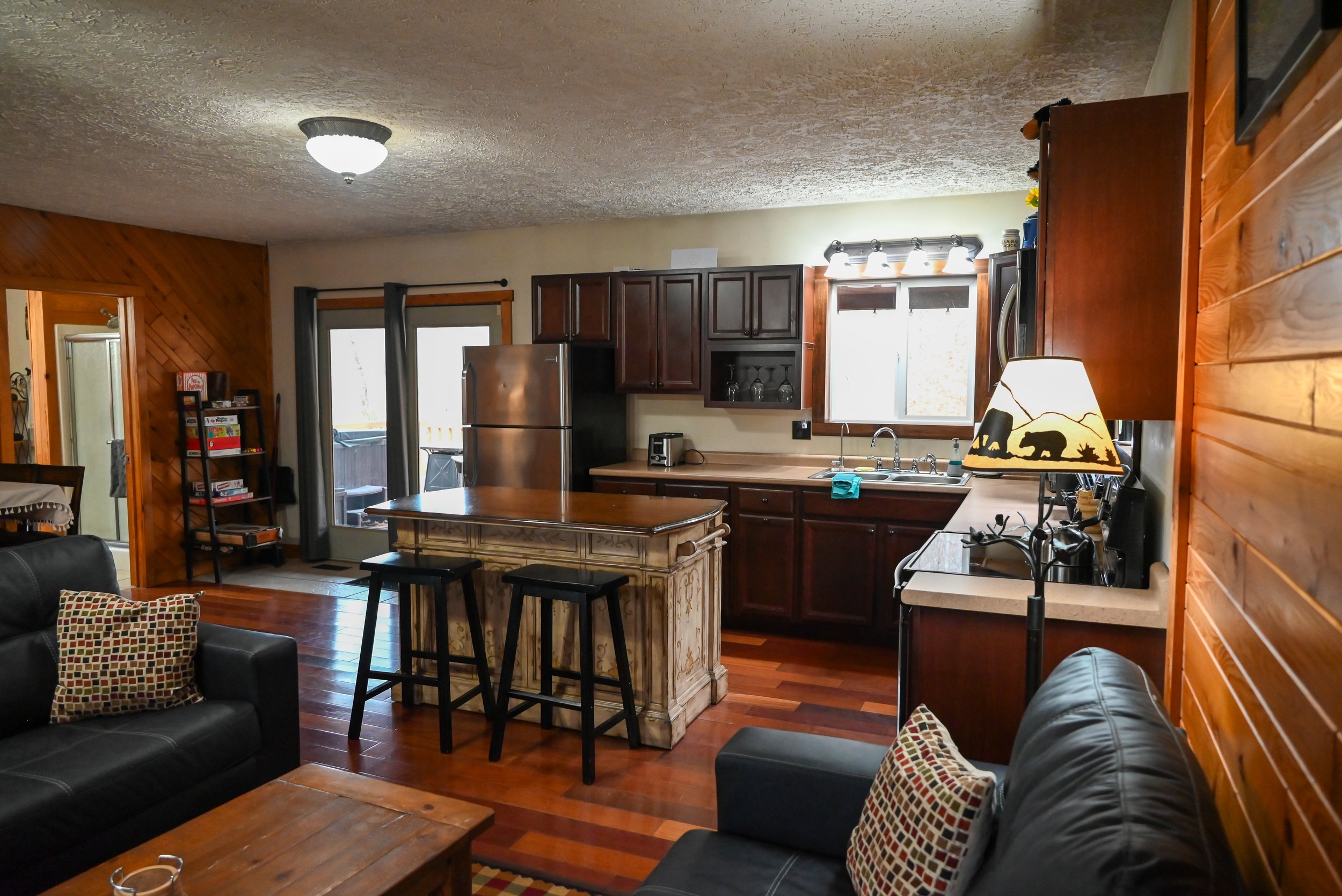 arm and inviting living‑kitchen space at Beary Cozy Cabin in Hocking Hills, perfect for couples to unwind, cook together, and enjoy a romantic getaway.