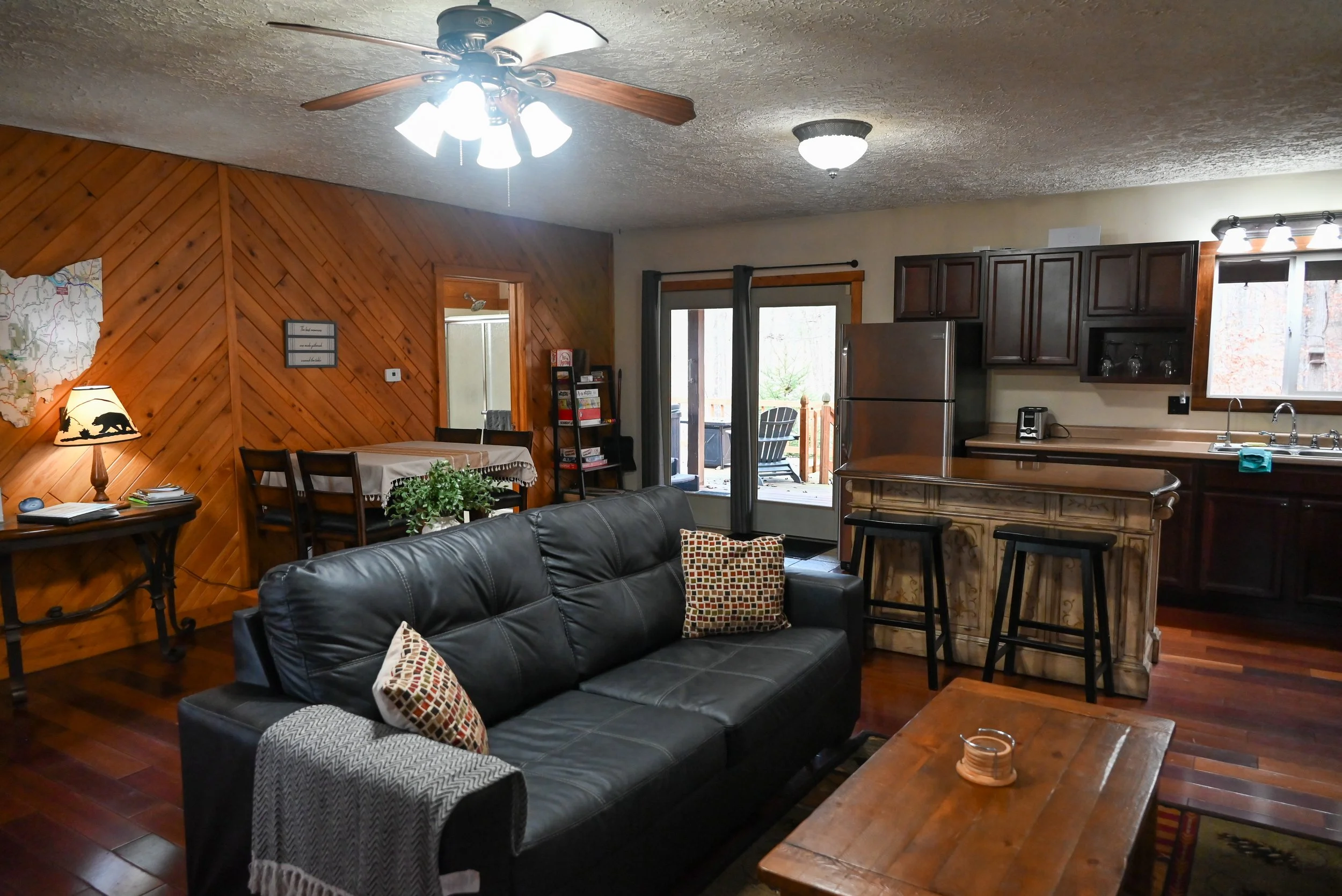 Romantic open‑concept kitchen and living area at Beary Cozy Cabin, perfect for couples to cook together and relax by the fire.