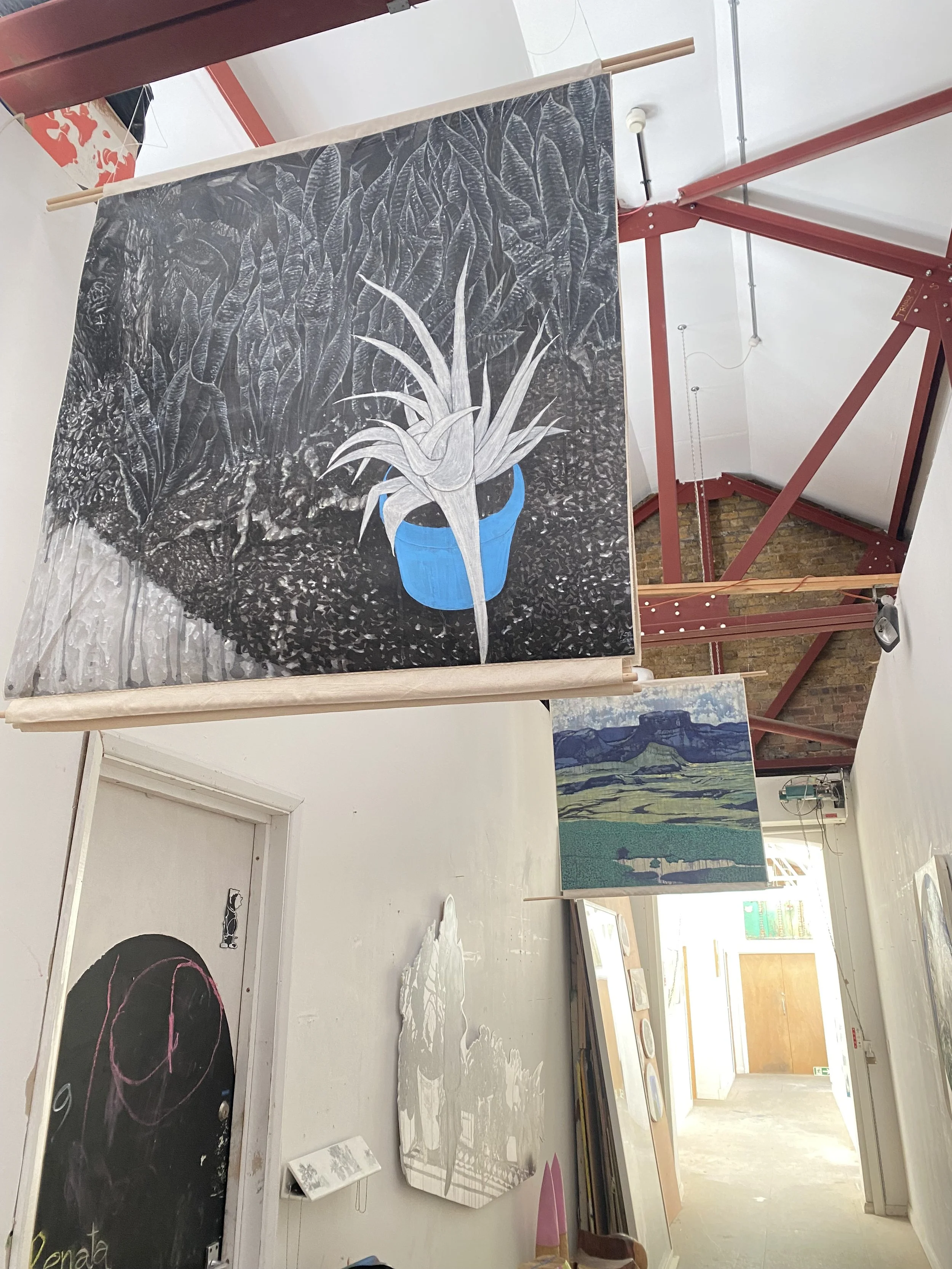 A large ink drawing hangs from the ceiling as a banner